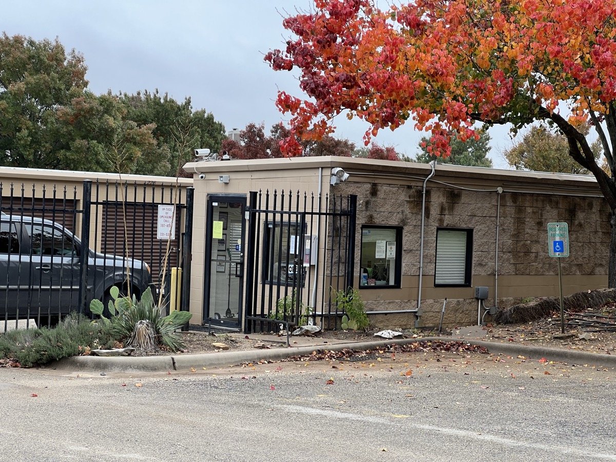 Antler Mini Storage office building with security gate and fall foliage