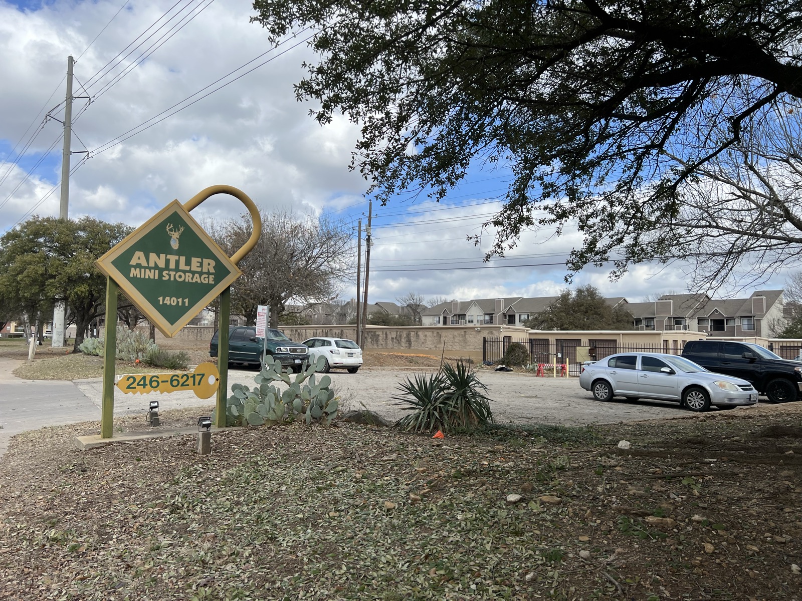 Antler Mini Storage sign with facility and parking area visible in background